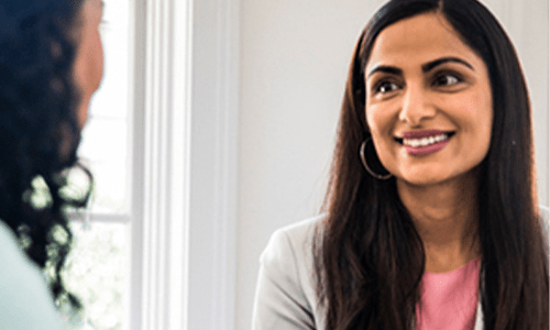 Academic and staff talking about global impact